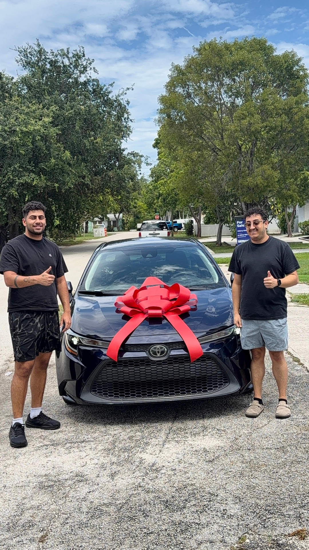 Customer delivery — vehicle handed over with a red delivery bow