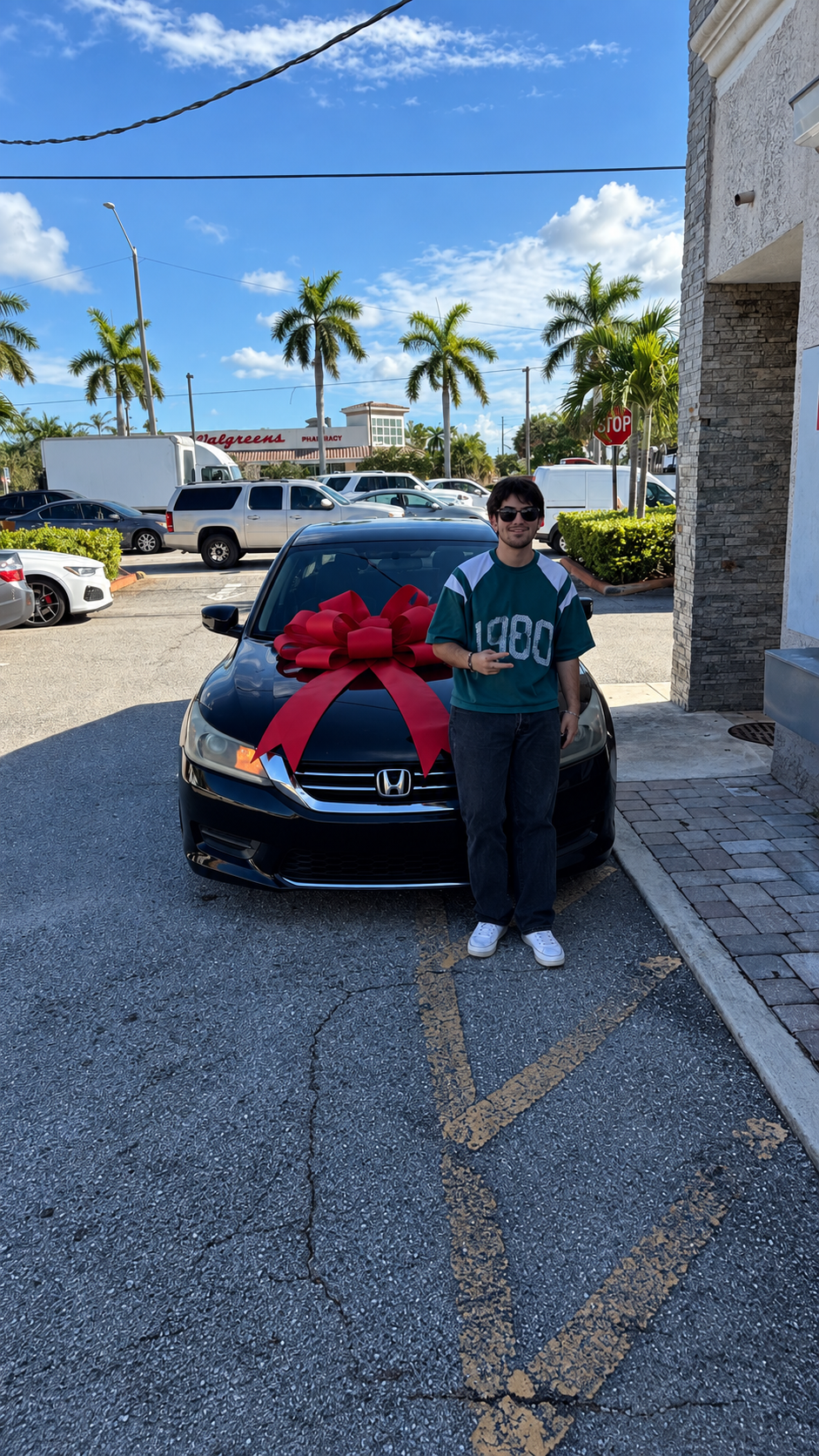 Customer with their delivered 2014 Honda Accord LX and a delivery bow